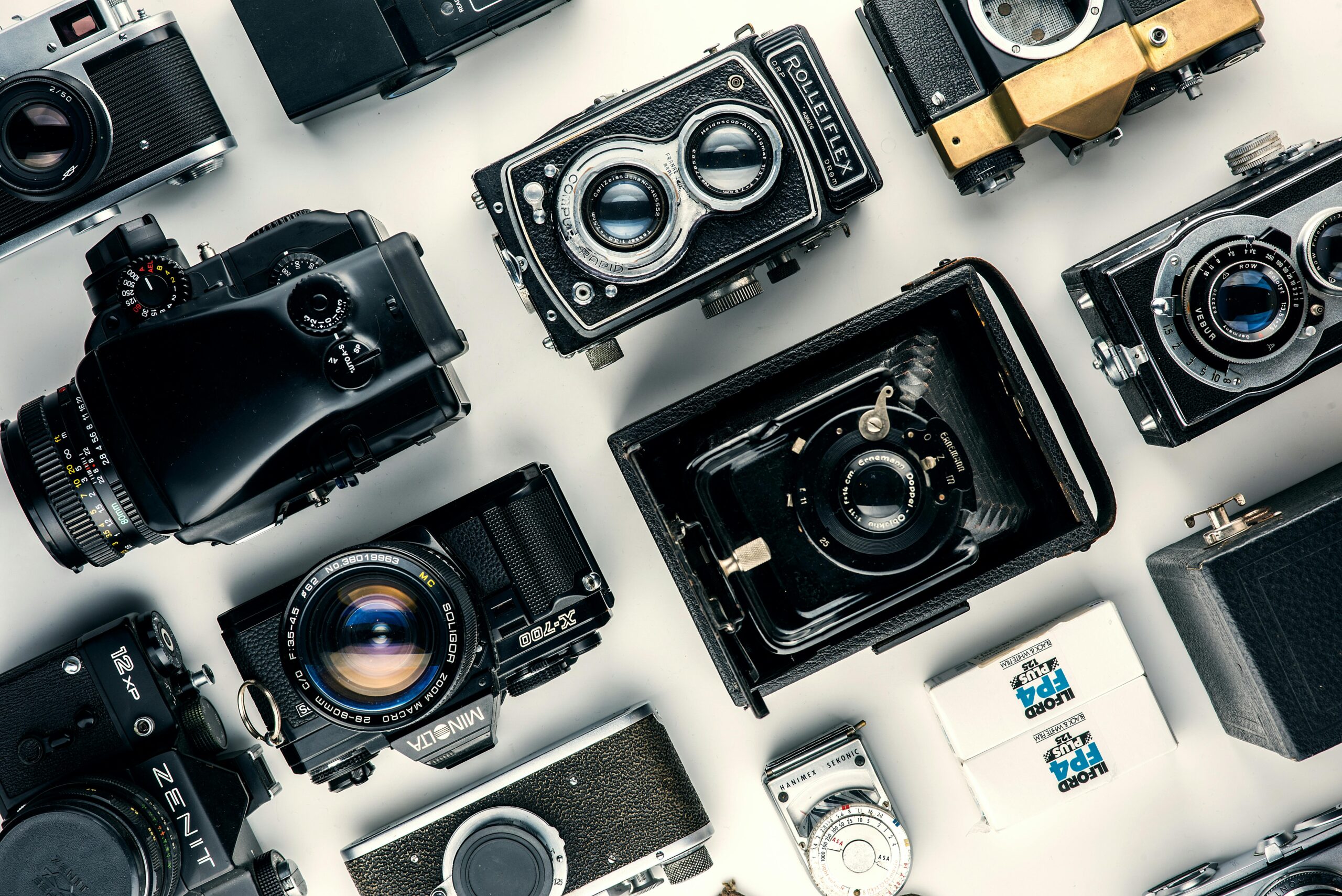 Flat lay of various vintage cameras showcasing classic design and retro charm.